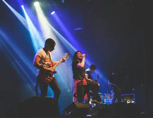 photo of male band performing on stadium