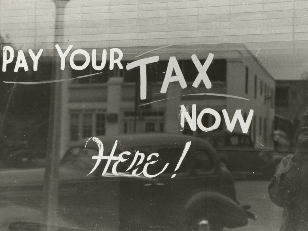 a sign that says pay your tax now here