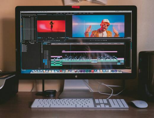 turned on iMac and Apple Magic Keyboard and mouse on table for performance marketers