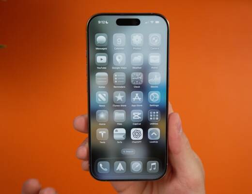 A person is holding an iPhone showcasing apps.