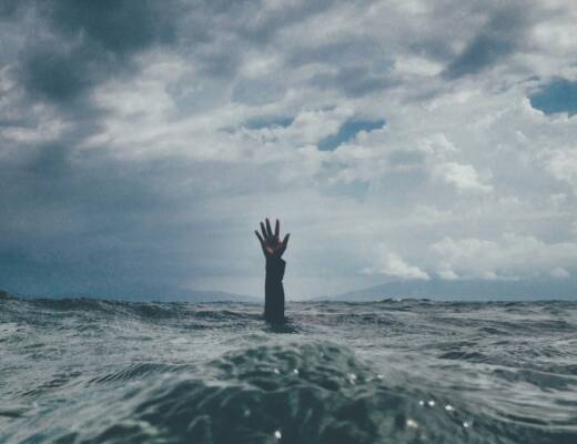 photo of person reach out above the water; burnout