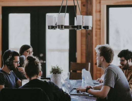 sittin people beside table inside room; Amateur in Meetings