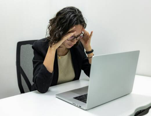a woman sitting in front of a laptop computer; Burnout