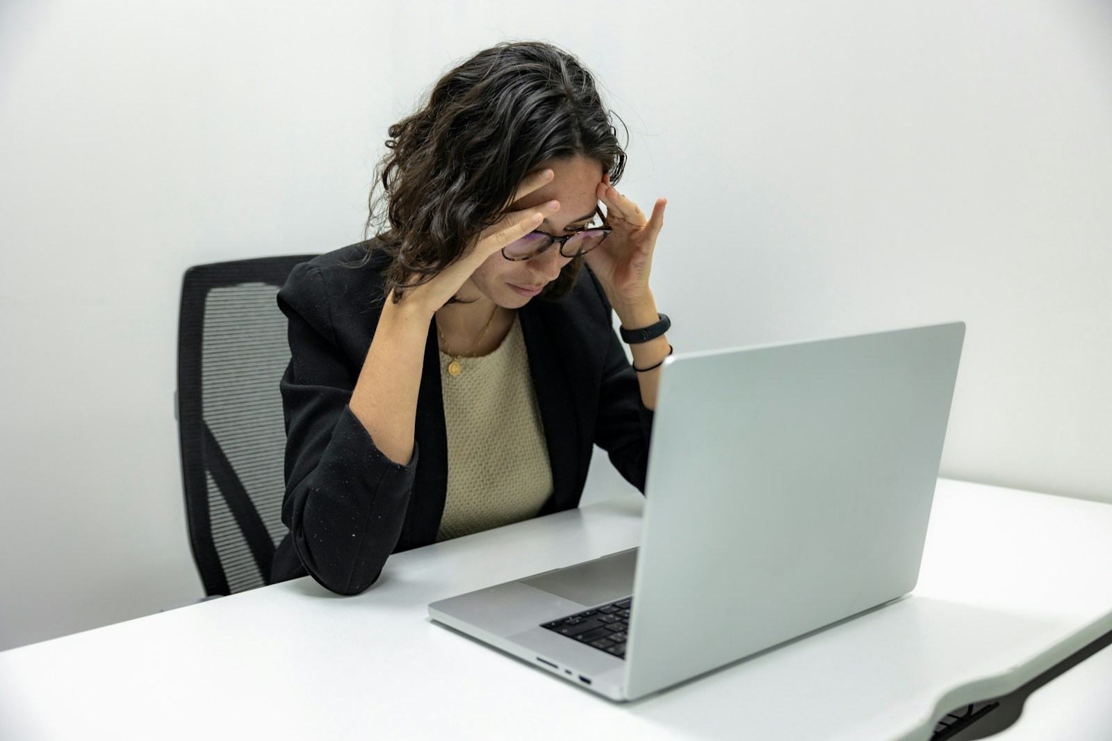 a woman sitting in front of a laptop computer; Burnout