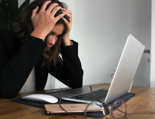 a woman sitting in front of a laptop computer; Burnout