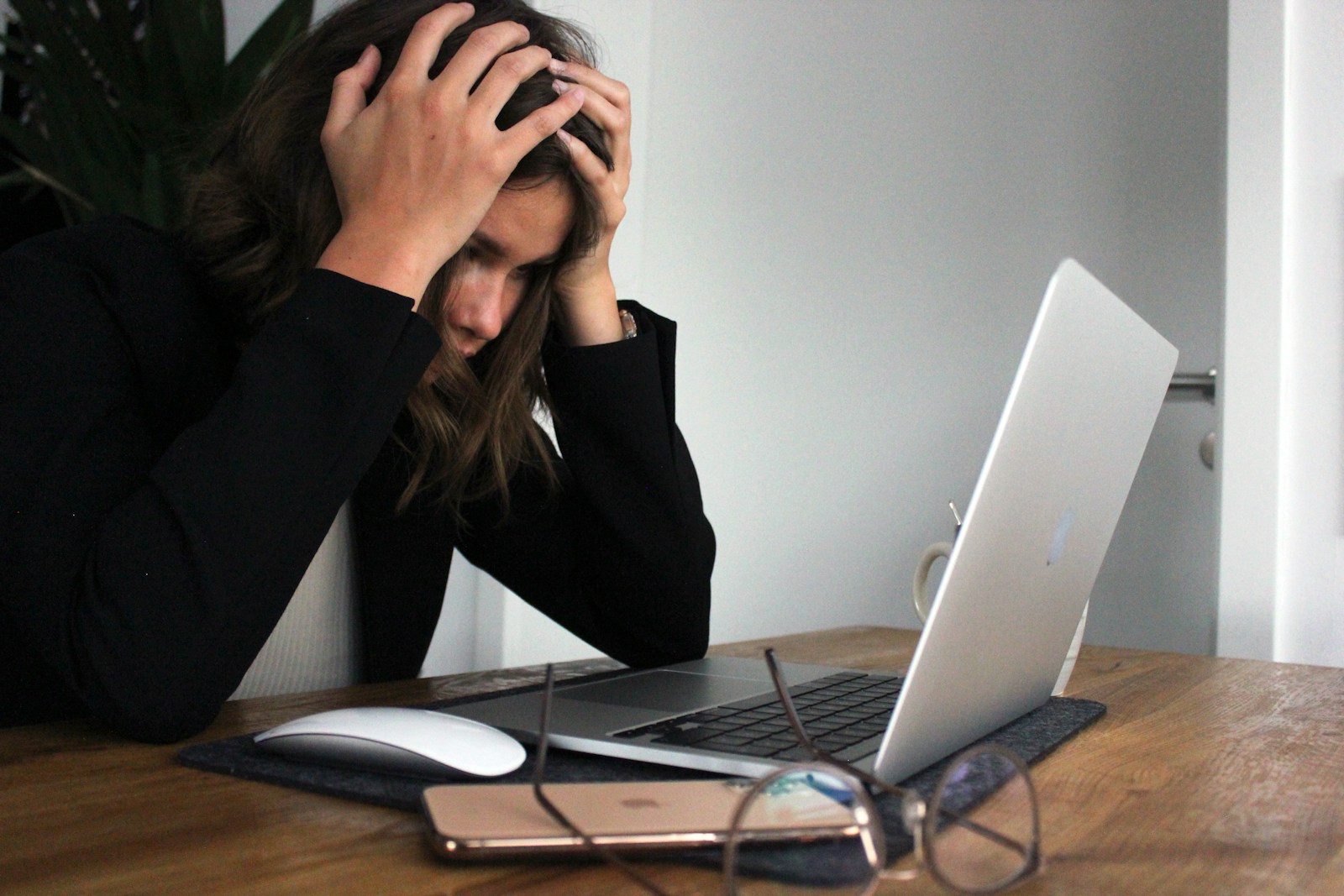 a woman sitting in front of a laptop computer; Burnout