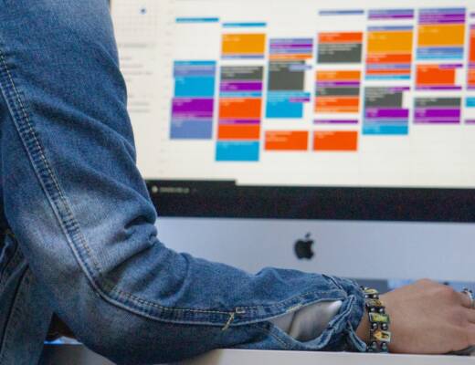 person with computer open to time blocked digital calendar; Calendar