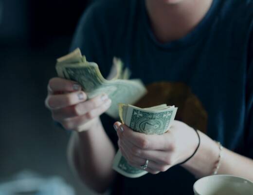 focus photography of person counting dollar banknotes; Cash Flow
