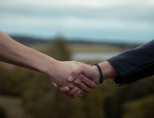 Two people shake hands in a symbolic gesture.; Co-Founder Relationship