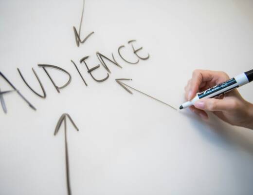 person writing on white paper; Content Marketing