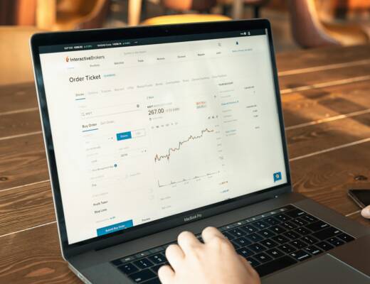 person using macbook pro on brown wooden table; Conversion Rate Optimization