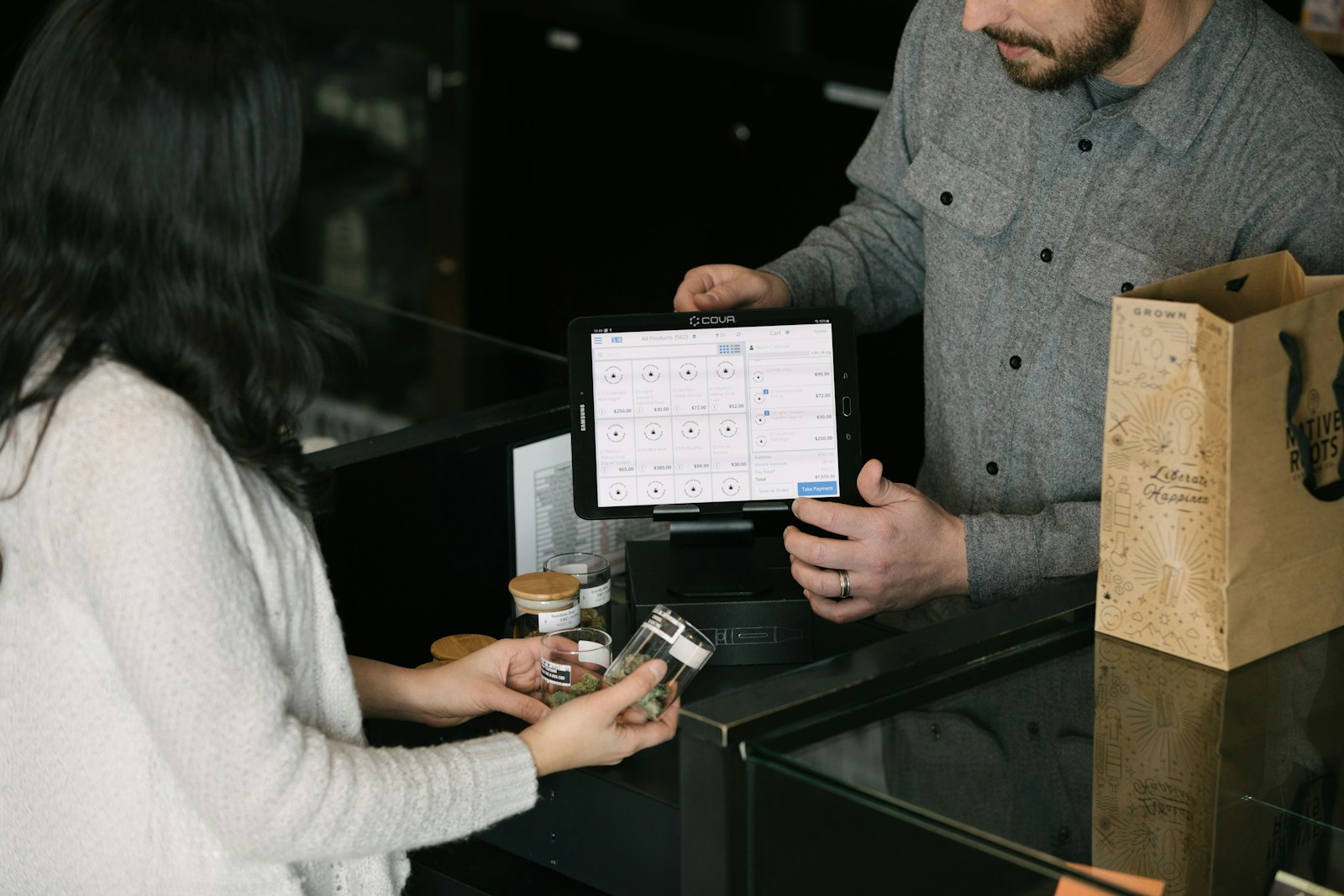 a man and a woman standing in front of a counter; Customer Acquisition
