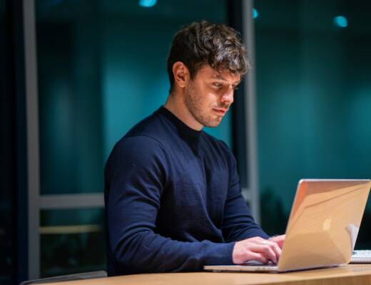 man in black long sleeve shirt using macbook; Early Traction