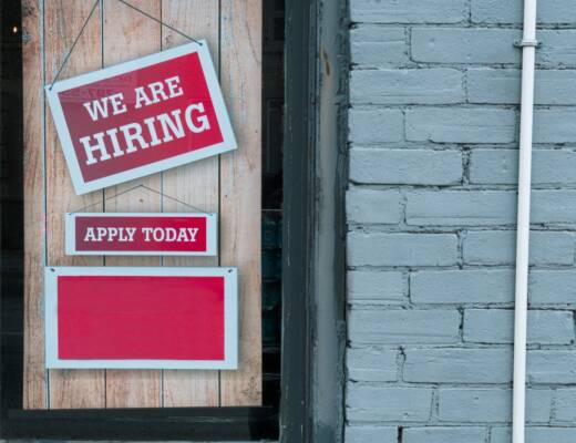 a sign that says we are hiring and apply today; first hire