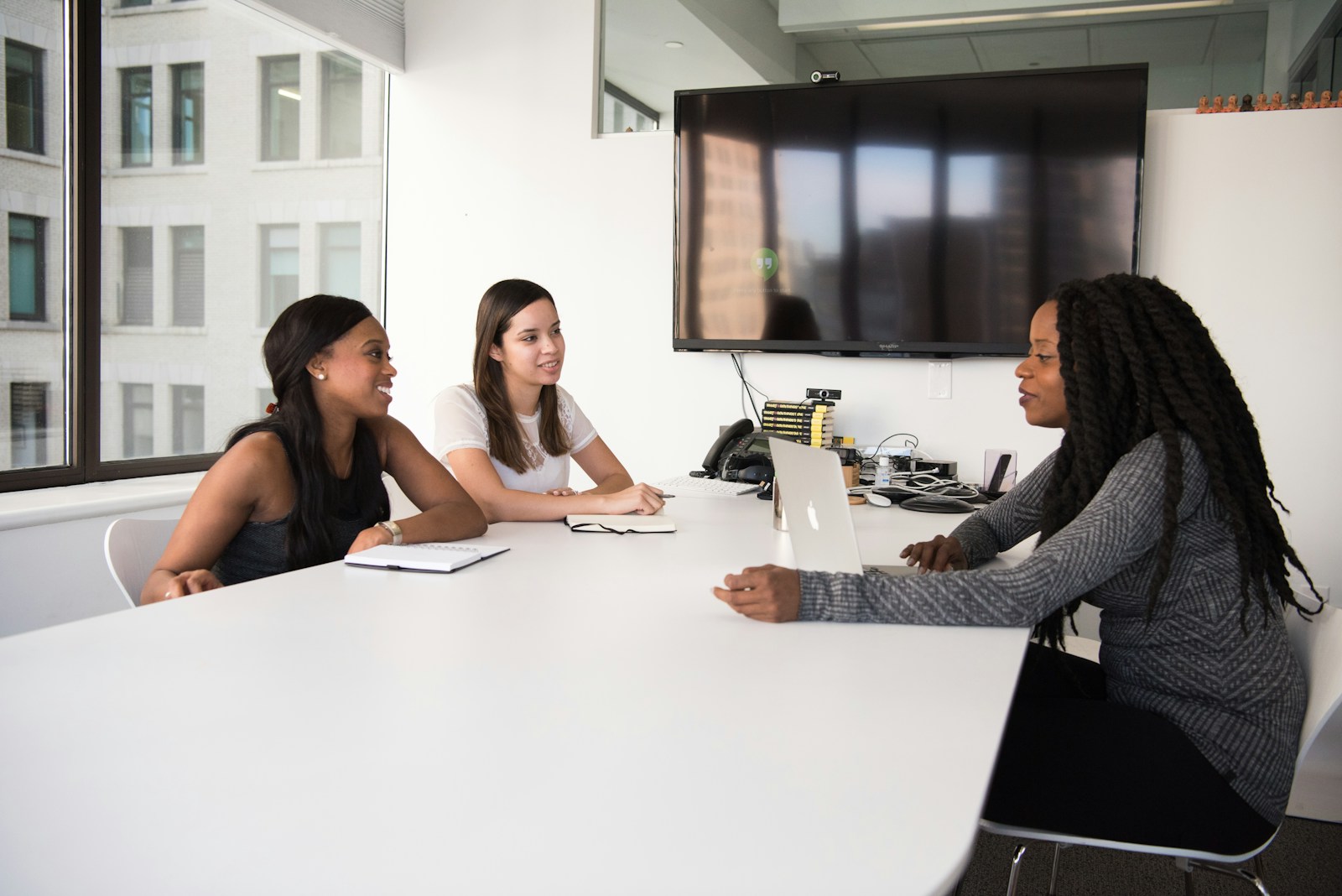 three women sitting at the table; Hire Your First Employee