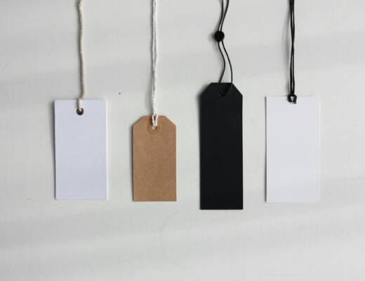 four paper card tags; pricing