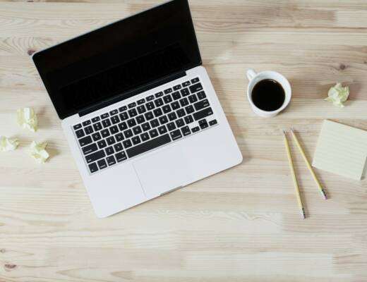 turned off MacBook Pro beside white ceramic mug filled with coffee; Landing Page MVP