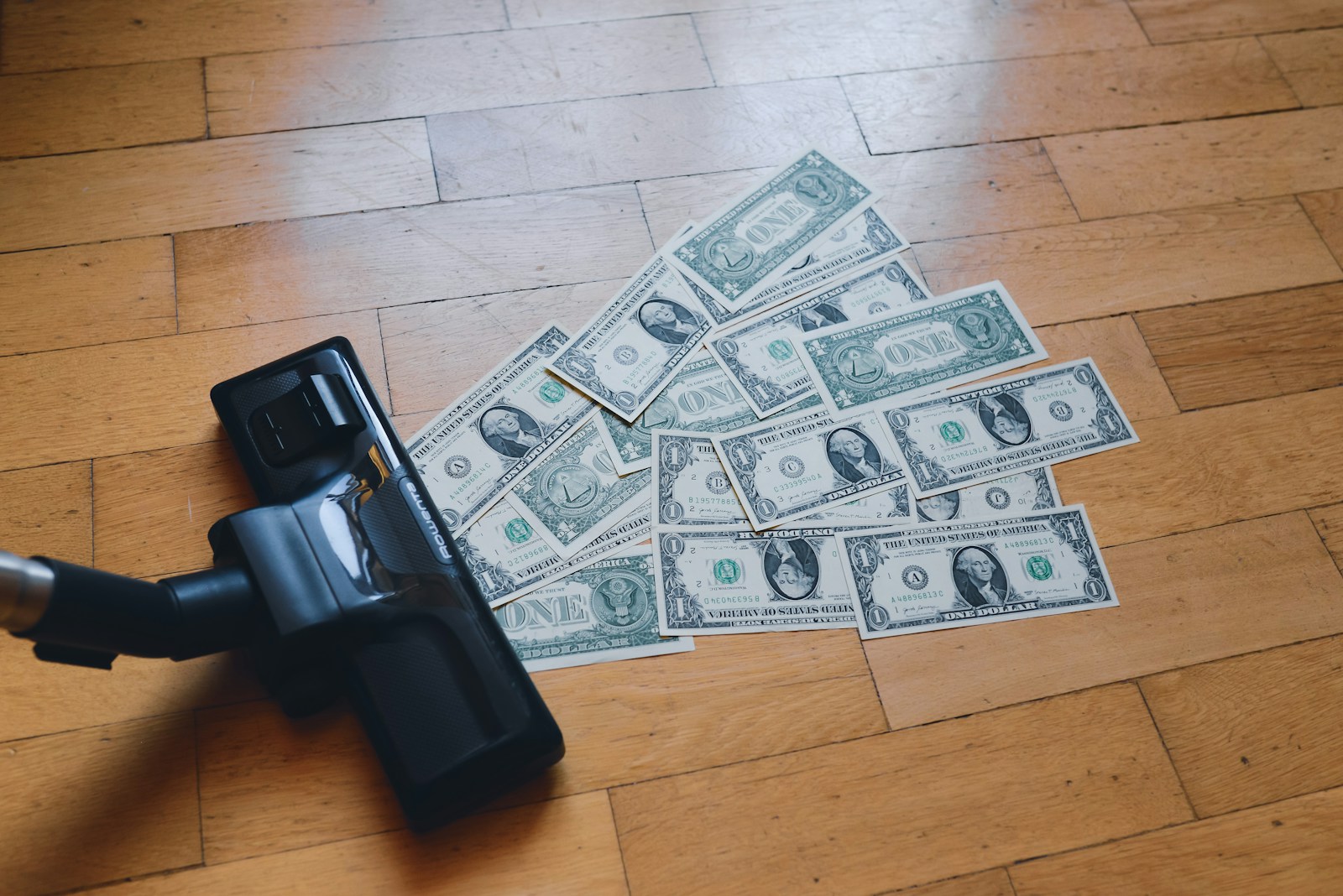 a pile of money sitting on top of a wooden floor; Money Conversation