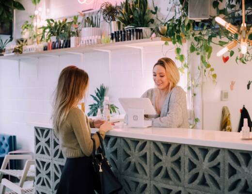 woman facing on white counter; reduce churn rate