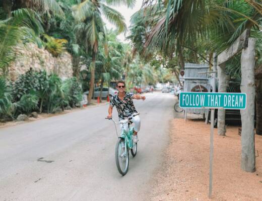 man rides bike pointing to follow that dream signage; Series A
