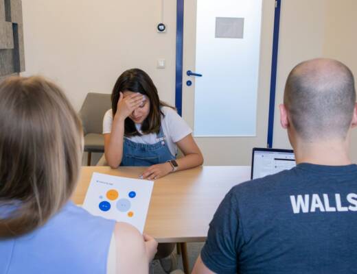 a group of people sitting around a table; Struggling Founder