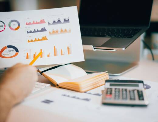 a person holding a piece of paper over a laptop; founders habits before CFO