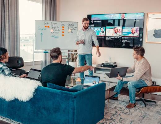 a group of employees sitting in modern workplace while leader hosts a learning session; training in the workplace