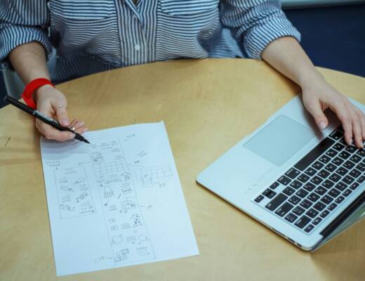 woman sketch on piece of paper while using laptop; better than you think