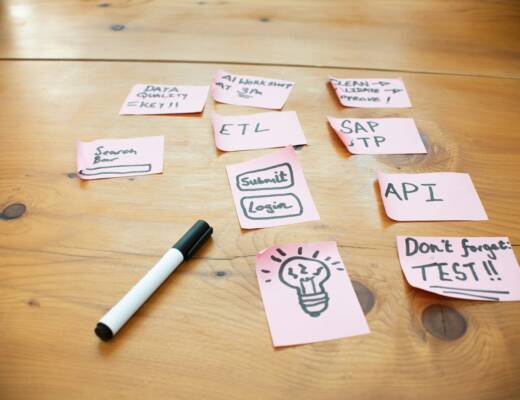 Sticky notes with words and drawings on wooden table; avoid feature creep