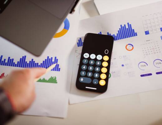 a calculator sitting on top of a table next to a laptop; pricing strategy