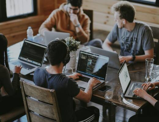 group of people using laptop computer; habits long-term success