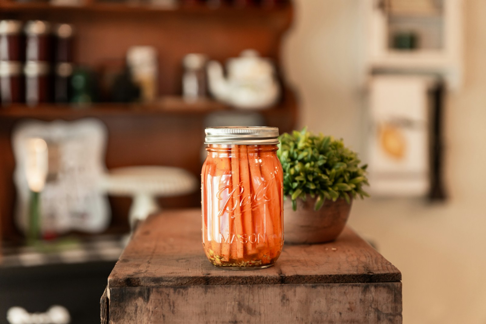 a jar of pickled carrots sitting on a table; enhancing product shelf life