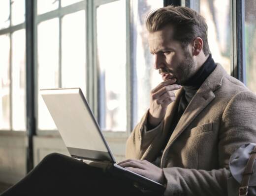 man holding his chin facing laptop computer; founders runway risk