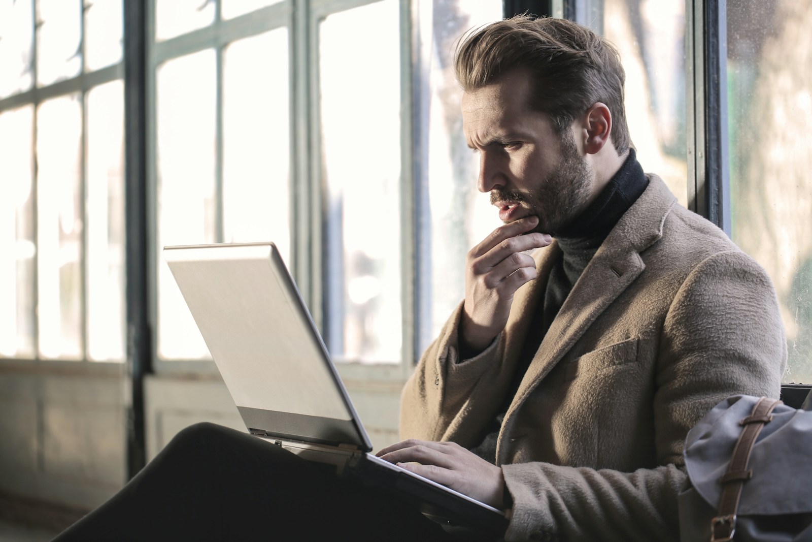 man holding his chin facing laptop computer; founders runway risk