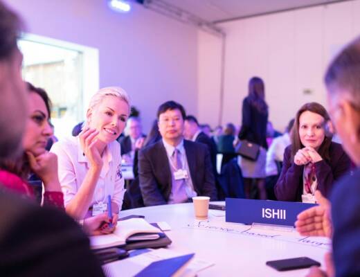 people sitting at the table making introductions during business event; professional name tags
