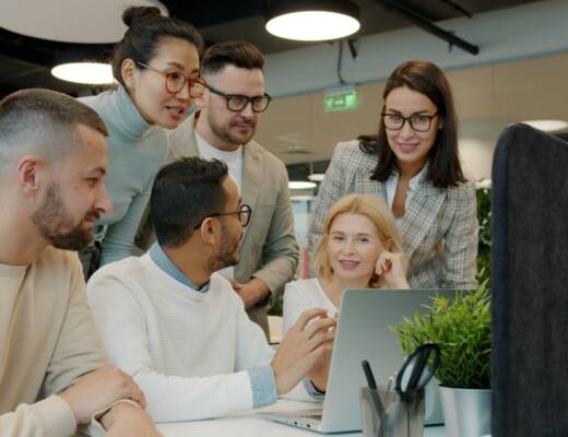 Diverse team collaborating around a laptop in office; startup culture killing momentum