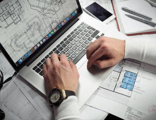 Image of person working on home design using laptop computer program; digital home design tools