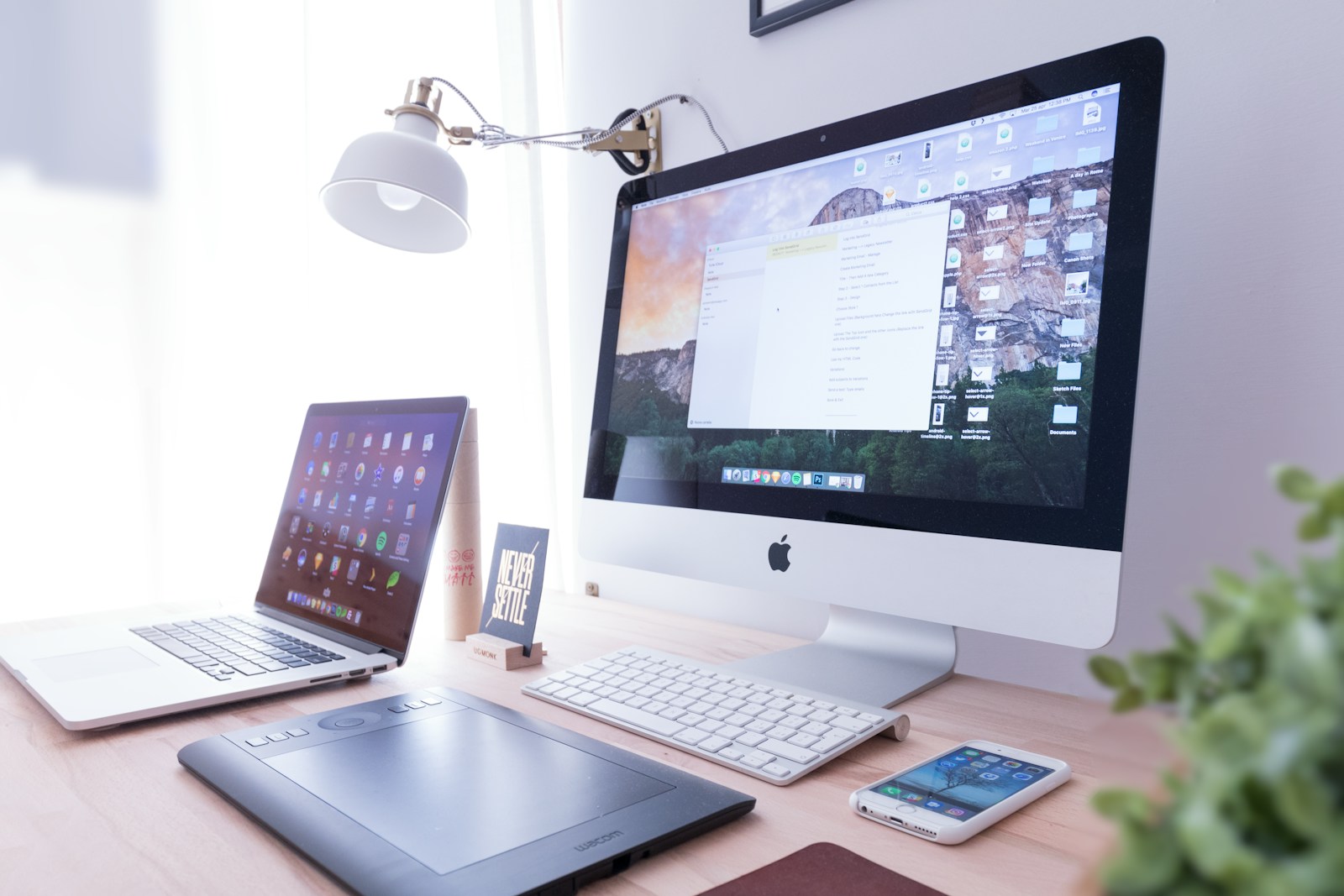 silver iMac near iPhone on brown wooden table; founders emerging tech