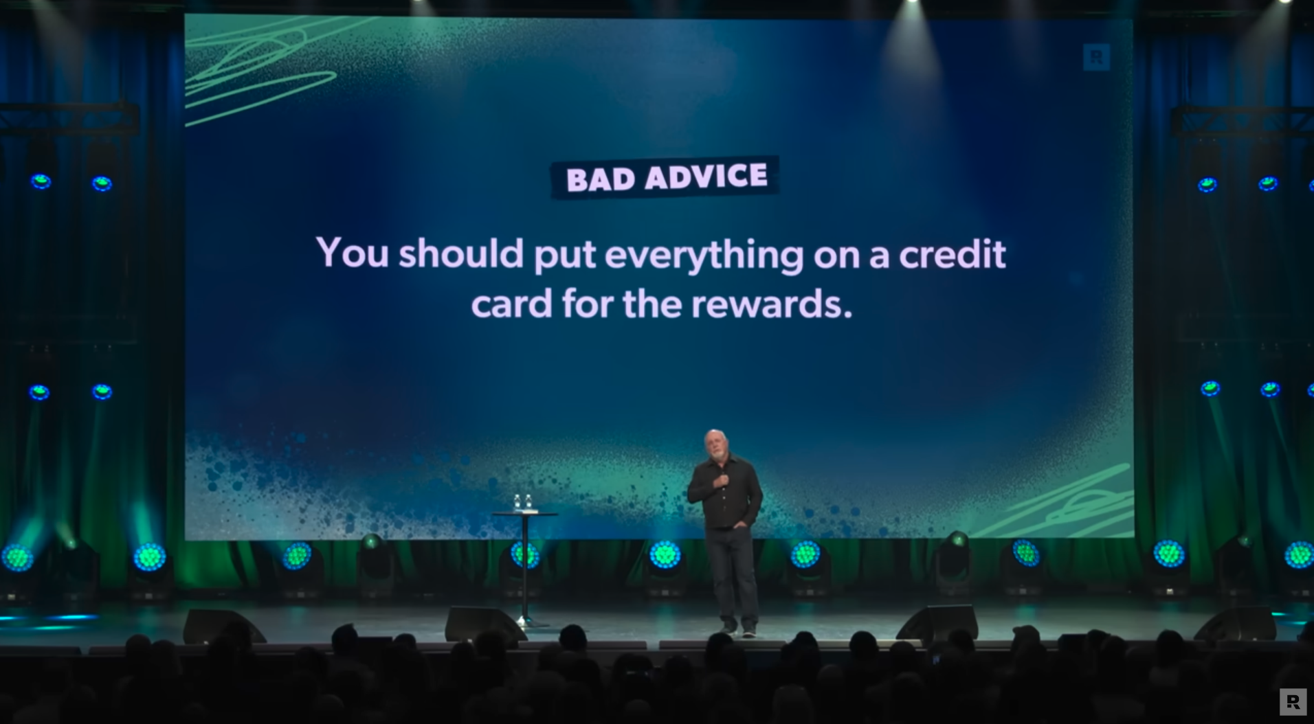 Image of The Ramsey Show Highlights Youtube channel host speaking at event; falling for money myths