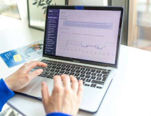 a person using a laptop computer on a desk; strategic tech stack guide