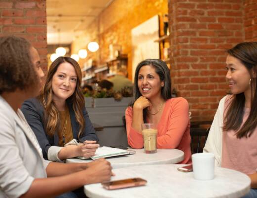 Four founders sitting at networking event discussing how business is going; build real relationships networking
