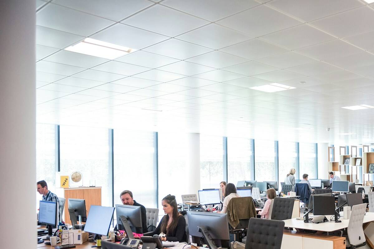 employees working at desks in customer service center; customer education sales tool