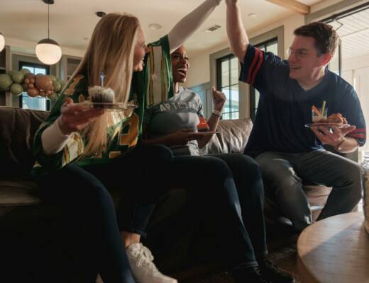 Friends celebrating sports team win with cupcakes; sports betting trap