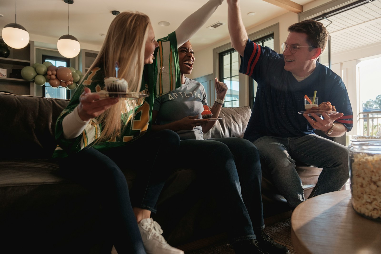 Friends celebrating sports team win with cupcakes; sports betting trap