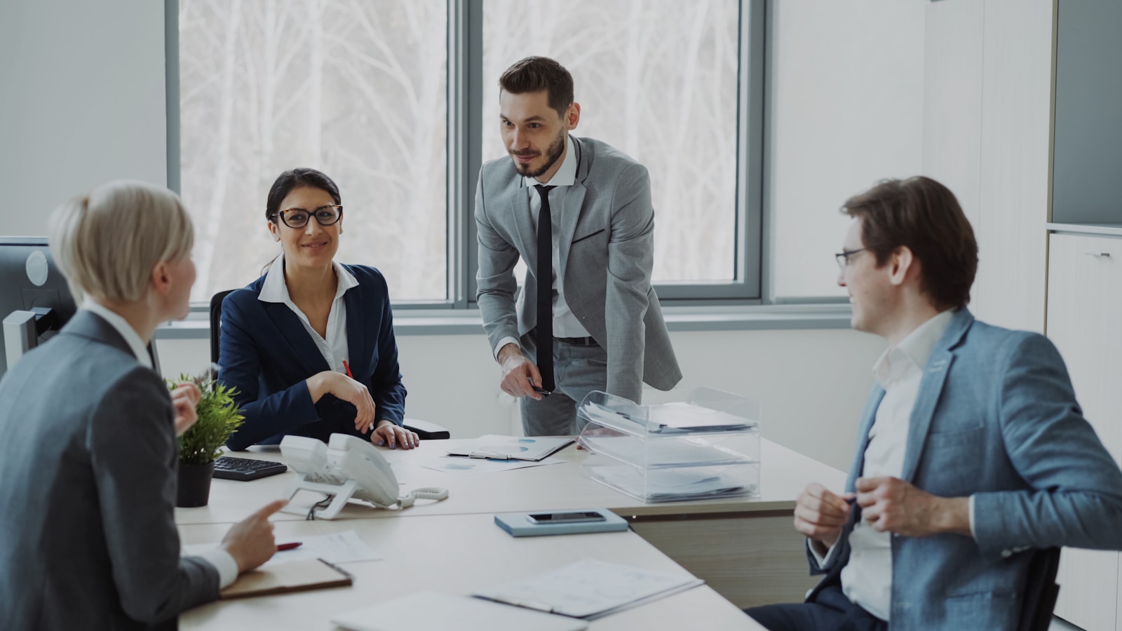 Business professionals collaborating around a conference table; founders net revenue retention