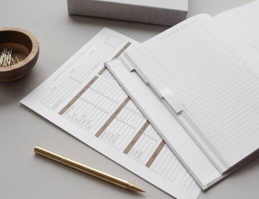 Image of financial documents and gold pen on desk; cosigning financial self-sabotage