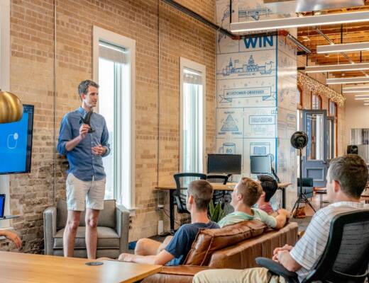 startup leader talking to team about new strategy; move fast mindset startups