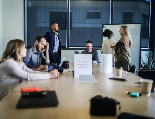 Startup team sitting at conference table; momentum raising funding
