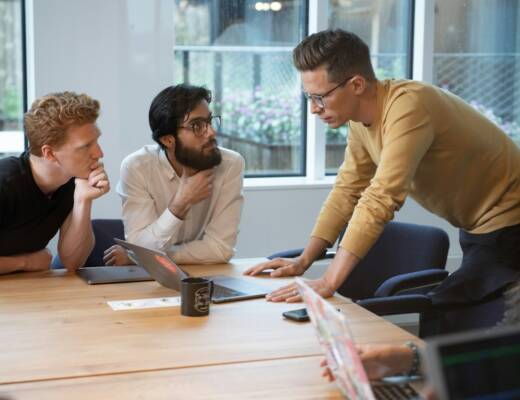 leader and a few team members chatting at conference table; pivot not panic