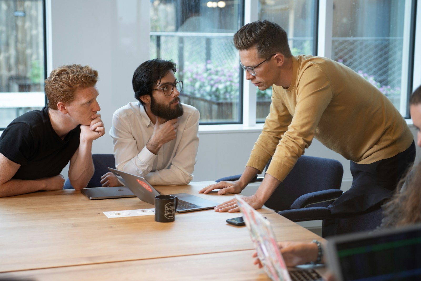 leader and a few team members chatting at conference table; pivot not panic